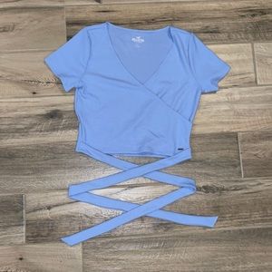 Light blue wrap shirt. Ties in the back. Size large.